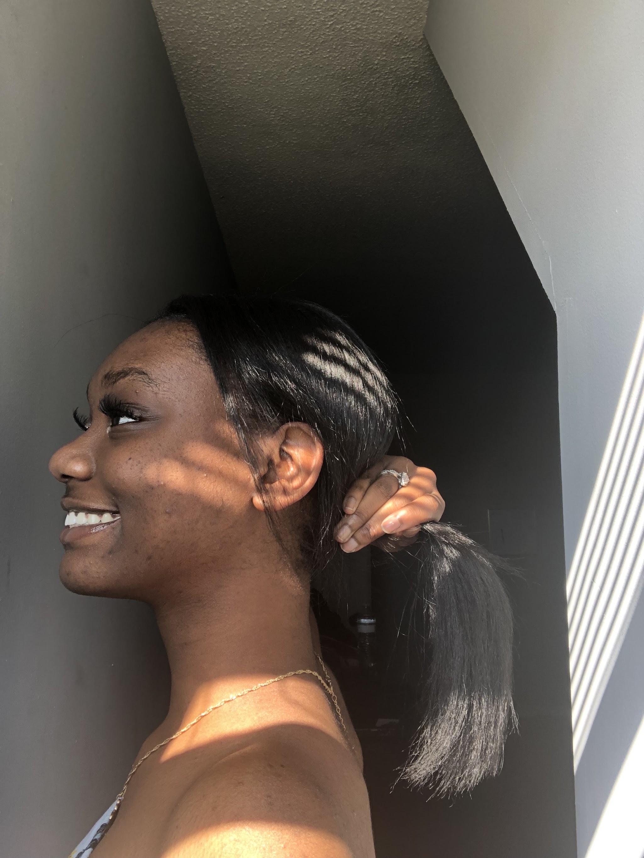 A client smiling with a sleek ponytail